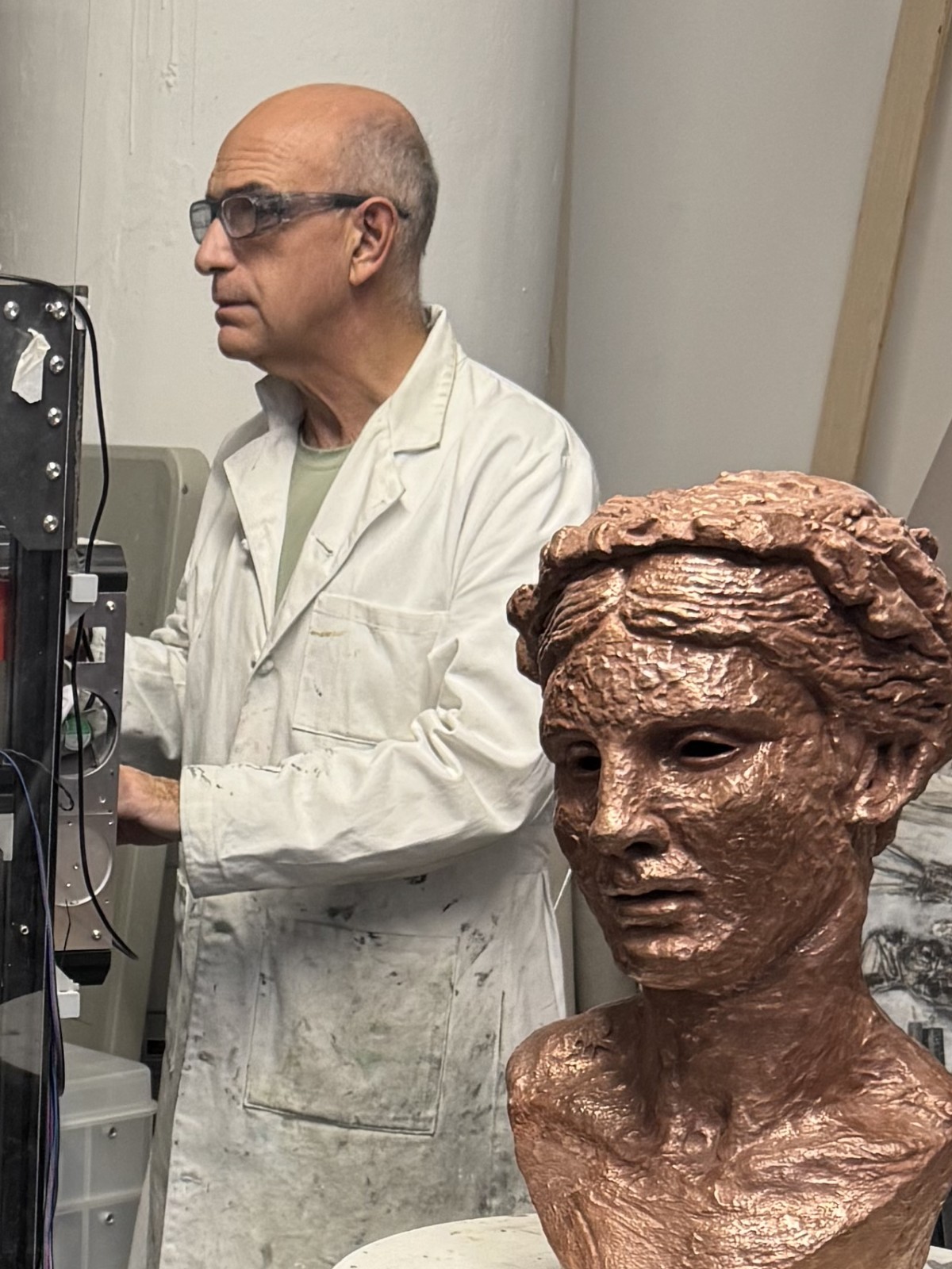 George Petrides in his studio beside a sculpted head